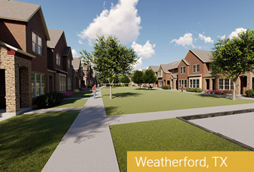 A paved walkway cutting through a grass lawn with homes on each side.